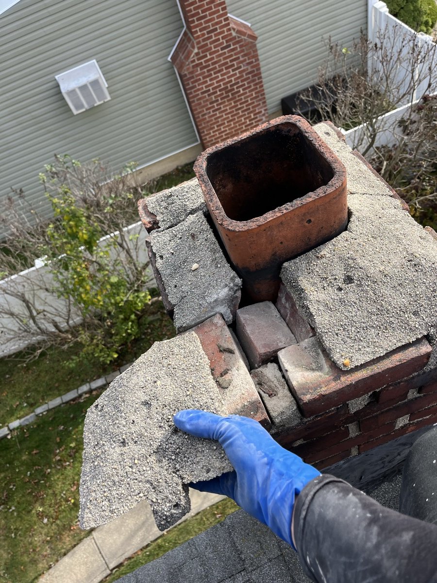 Crown demolition in progress with hand pulling damaged pieces