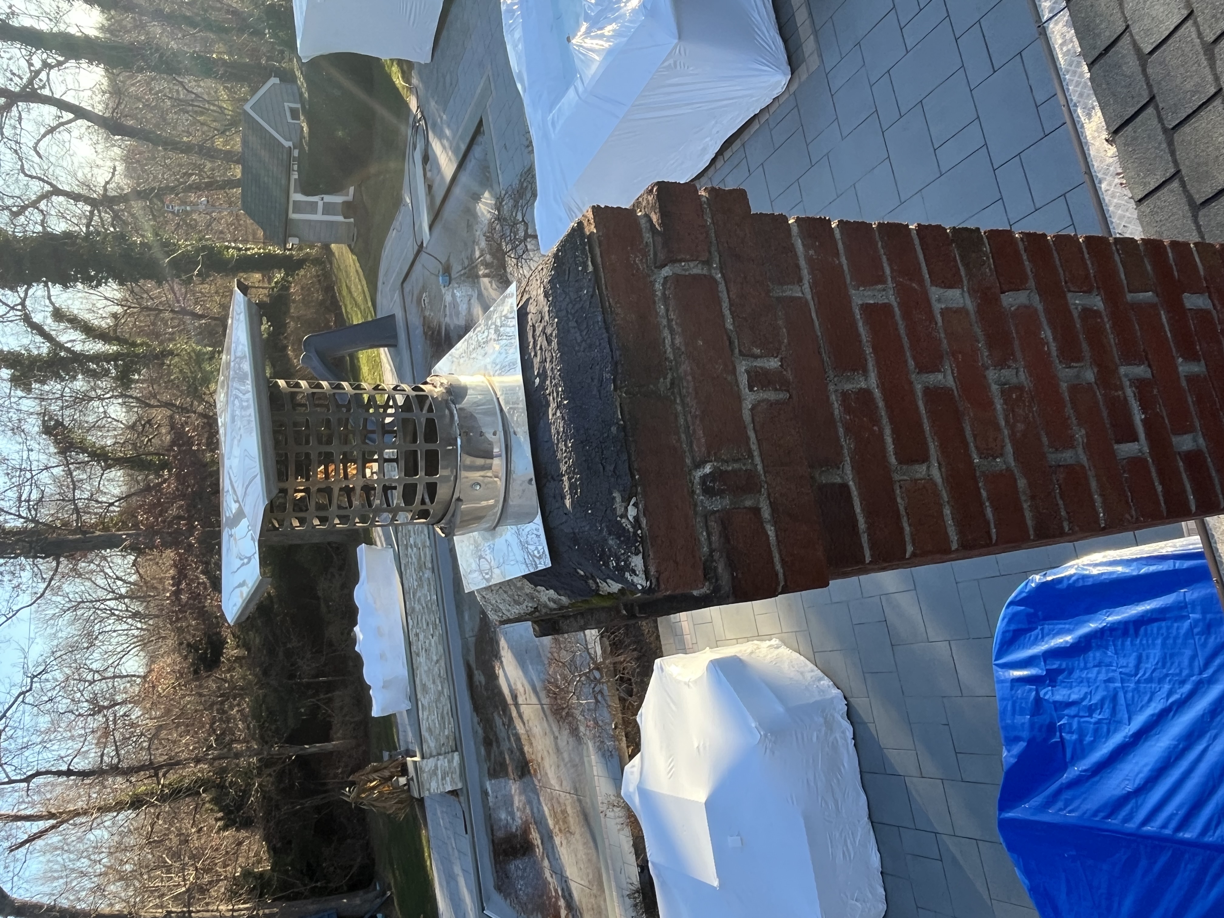 Brick chimney with cap before full restoration